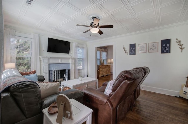 living room with dark wood-style floors, a fireplace, an ornate ceiling, and baseboards