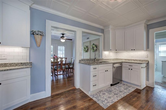 kitchen featuring stainless steel dishwasher, a sink, dark wood finished floors, and white cabinets