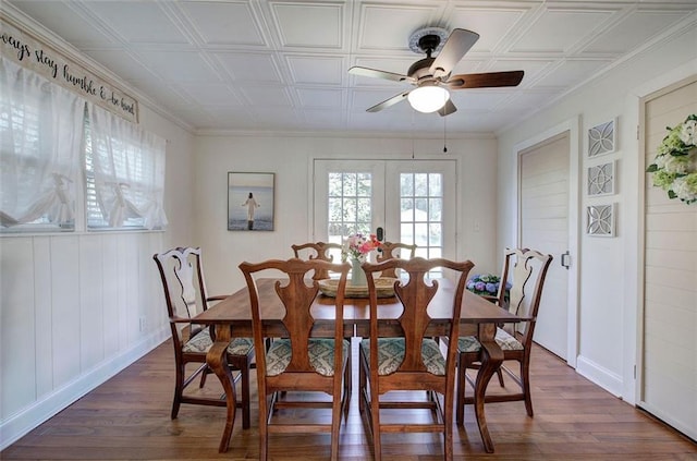 dining area featuring baseboards, dark wood finished floors, a ceiling fan, an ornate ceiling, and french doors