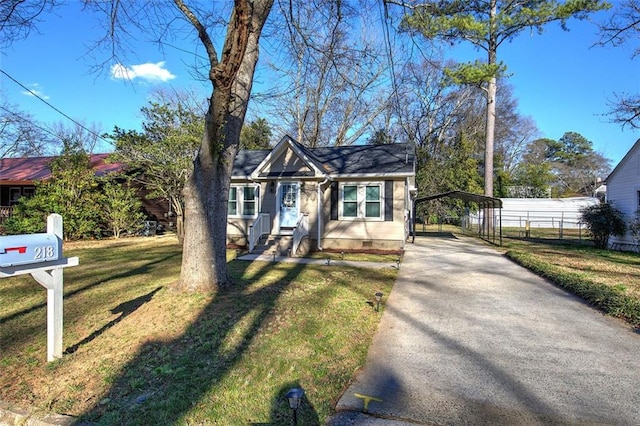 bungalow-style home with a carport, driveway, a front lawn, and fence