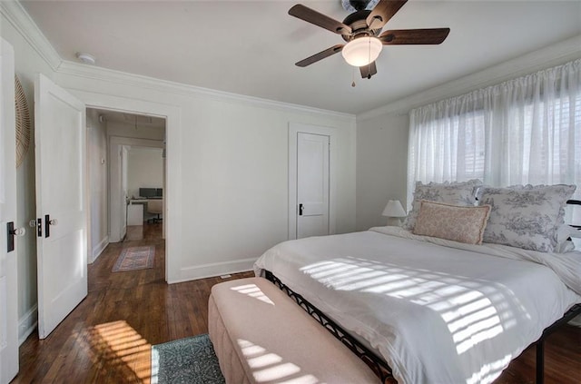 bedroom featuring baseboards, ceiling fan, wood finished floors, crown molding, and a closet