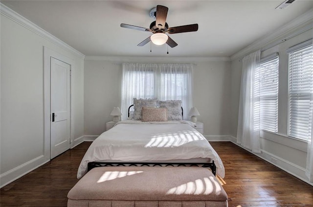 bedroom with dark wood-style flooring, multiple windows, and crown molding