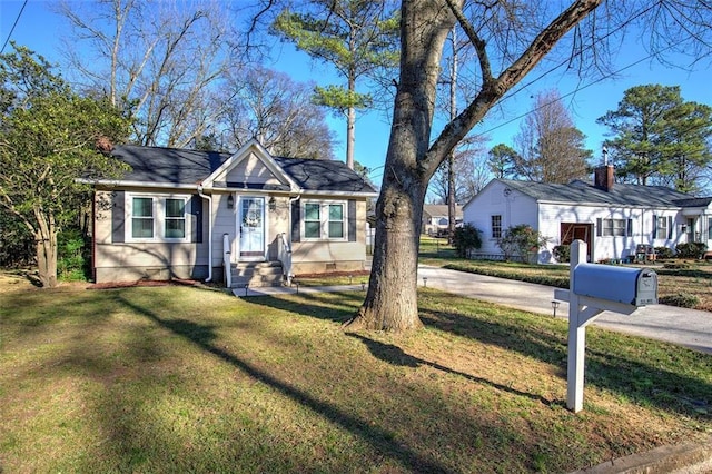 bungalow-style house featuring a front yard