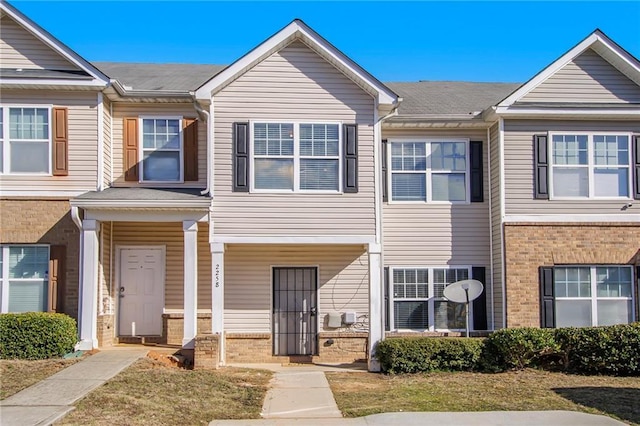 townhome / multi-family property featuring brick siding