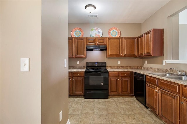 kitchen with under cabinet range hood, a sink, light countertops, brown cabinets, and black appliances