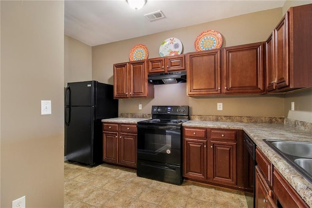 kitchen with visible vents, under cabinet range hood, light countertops, black appliances, and a sink