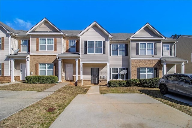 townhome / multi-family property featuring brick siding