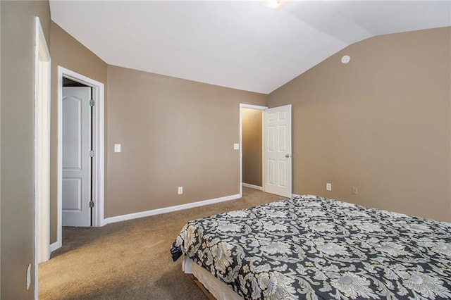 bedroom with vaulted ceiling, carpet, and baseboards