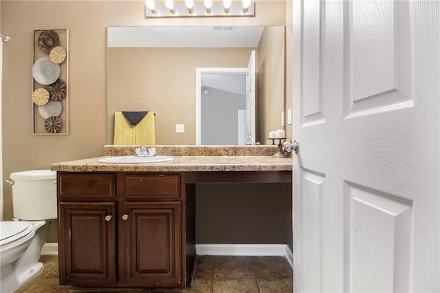 bathroom with toilet, visible vents, and vanity