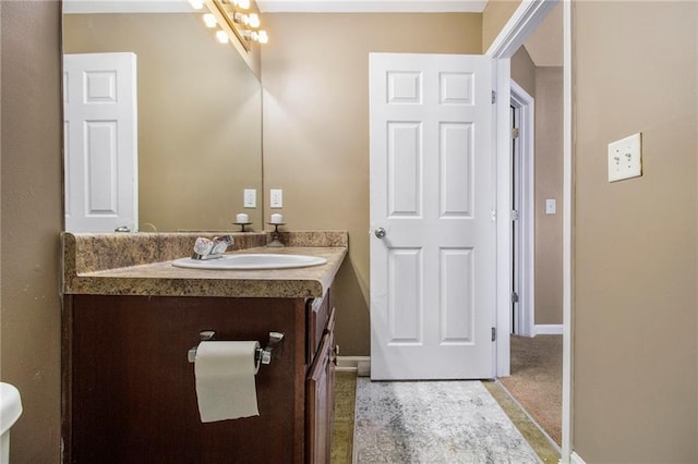 bathroom featuring baseboards and vanity