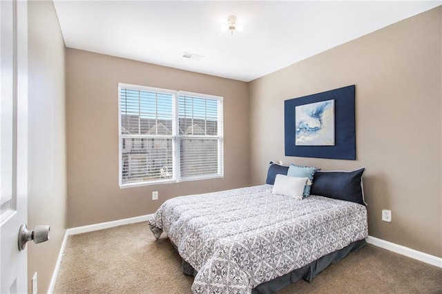 bedroom with carpet, visible vents, and baseboards