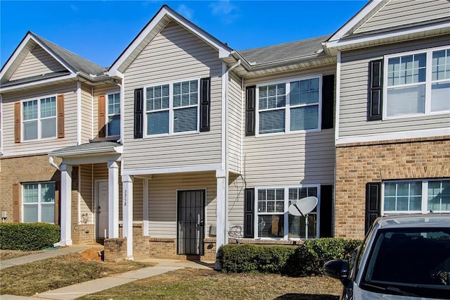 townhome / multi-family property featuring brick siding