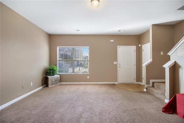 interior space with stairway, visible vents, and baseboards