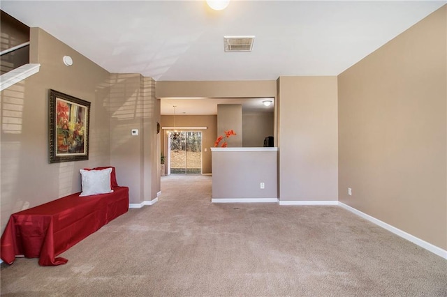 interior space with carpet flooring, visible vents, and baseboards