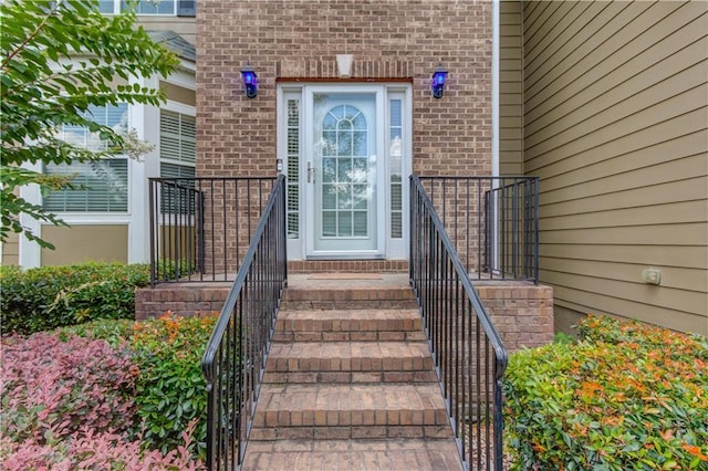 view of exterior entry with brick siding