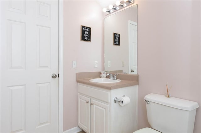 bathroom with toilet and vanity