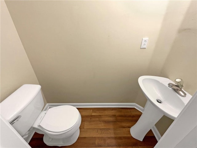 20 Pine Canyon Dr SW Unit 24, Atlanta, GA 30331 - half bath with toilet, baseboards, wood finished floors, and a sink