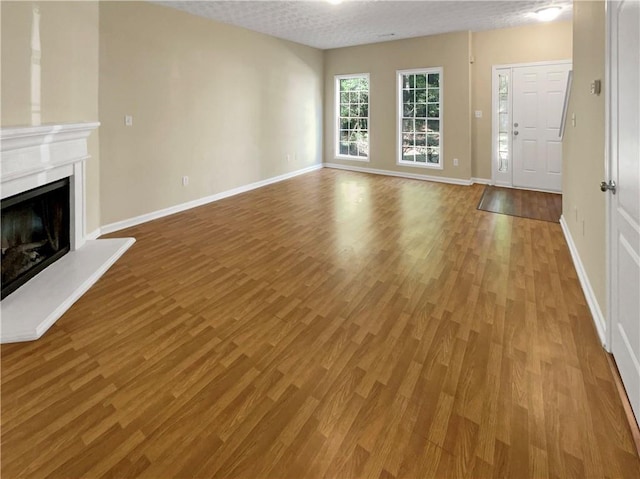 20 Pine Canyon Dr SW Unit 24, Atlanta, GA 30331 - unfurnished living room with baseboards, a fireplace with raised hearth, and wood finished floors