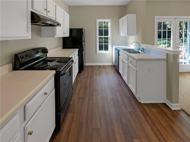 20 Pine Canyon Dr SW Unit 24, Atlanta, GA 30331 - kitchen with dark wood-type flooring, black appliances, under cabinet range hood, a sink, and light countertops