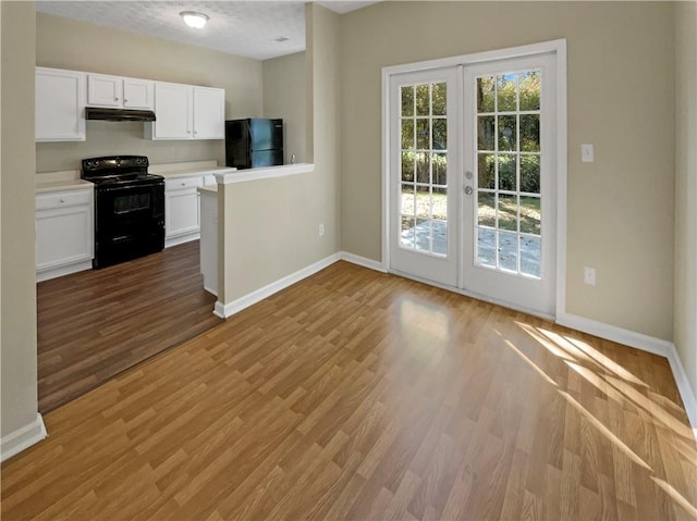 20 Pine Canyon Dr SW Unit 24, Atlanta, GA 30331 - kitchen featuring white cabinets, black appliances, under cabinet range hood, french doors, and baseboards