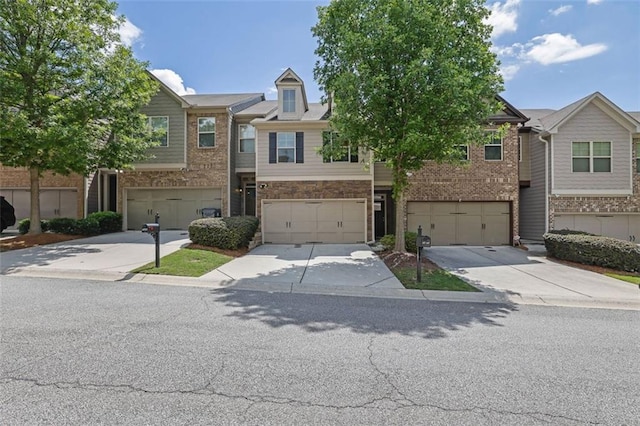 4965 Whiteoak Walk SE Unit 19, Smyrna, GA 30080 - view of property with driveway, a garage, and brick siding