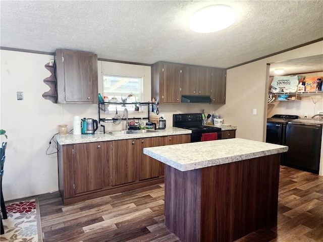 kitchen with sink, dark hardwood / wood-style flooring, a center island, washing machine and clothes dryer, and black / electric stove