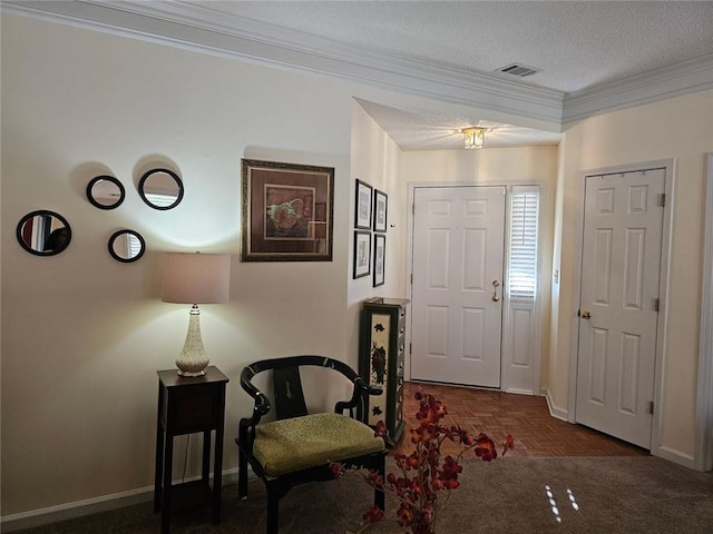 entrance foyer featuring a textured ceiling, dark parquet flooring, and crown molding