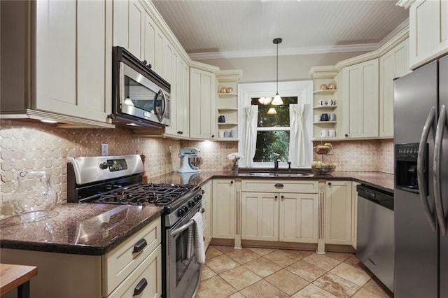 kitchen with appliances with stainless steel finishes, hanging light fixtures, tasteful backsplash, light tile floors, and sink