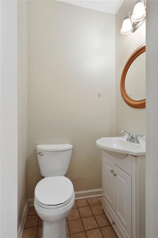 bathroom with toilet, tile flooring, and vanity