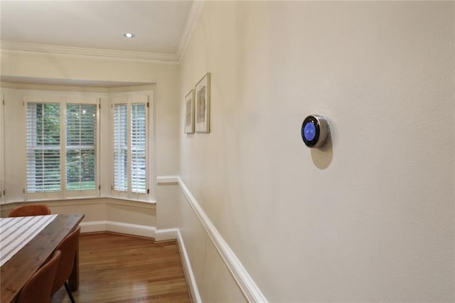 hall featuring ornamental molding and wood-type flooring