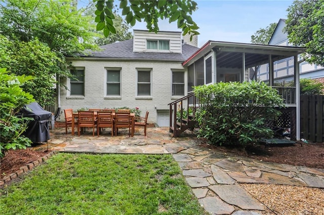 rear view of property with a patio area and a sunroom