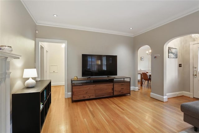 living room featuring ornamental molding and light wood-type flooring