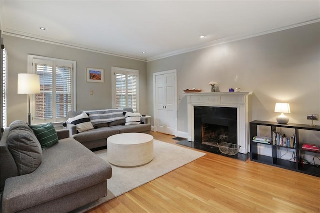 living room featuring light hardwood / wood-style flooring and ornamental molding