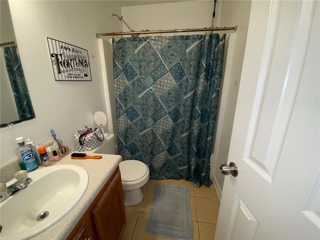 bathroom featuring tile patterned floors, vanity, walk in shower, and toilet