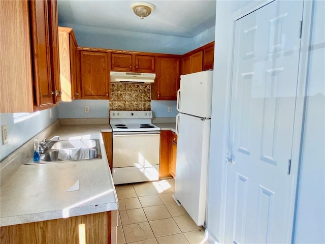 kitchen featuring white appliances, sink, and light tile patterned floors