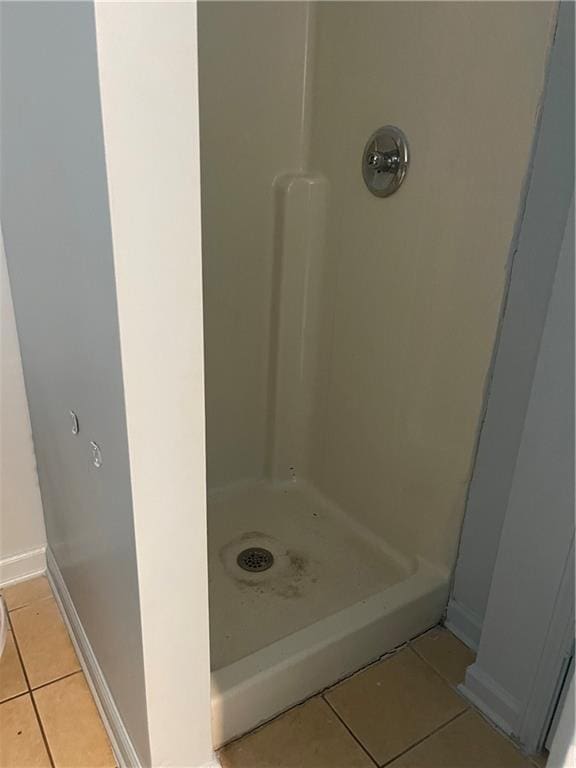 bathroom featuring a shower and tile patterned flooring