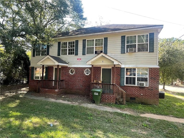 view of front of home with a front lawn and central AC unit