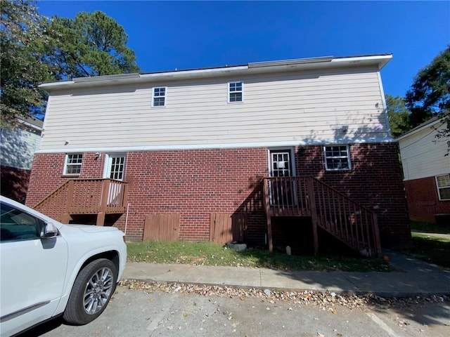 rear view of property featuring a deck