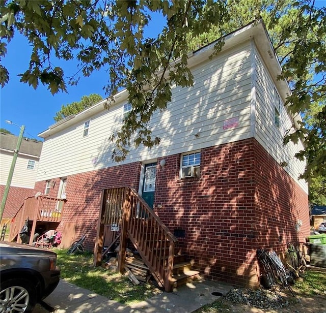 view of front of house with cooling unit and a wooden deck