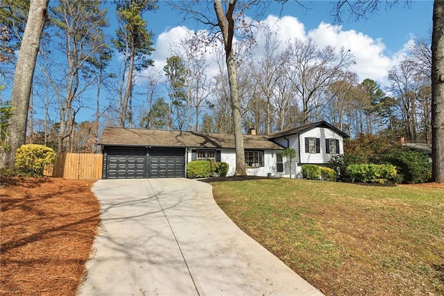 split level home with a garage and a front lawn