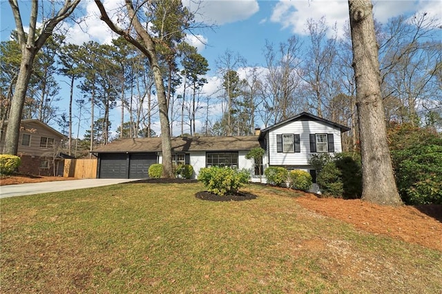 split level home featuring a garage and a front yard