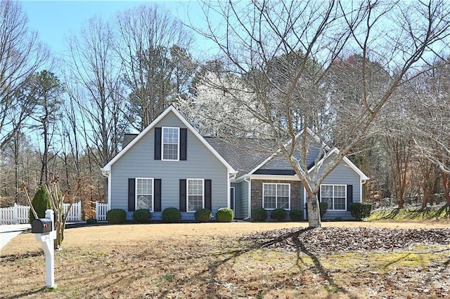 traditional-style house featuring fence