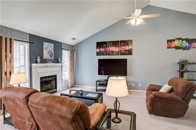 living area with a healthy amount of sunlight, visible vents, a fireplace, and carpet flooring