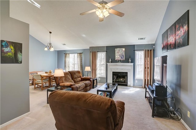 living area featuring visible vents, vaulted ceiling, light carpet, and baseboards