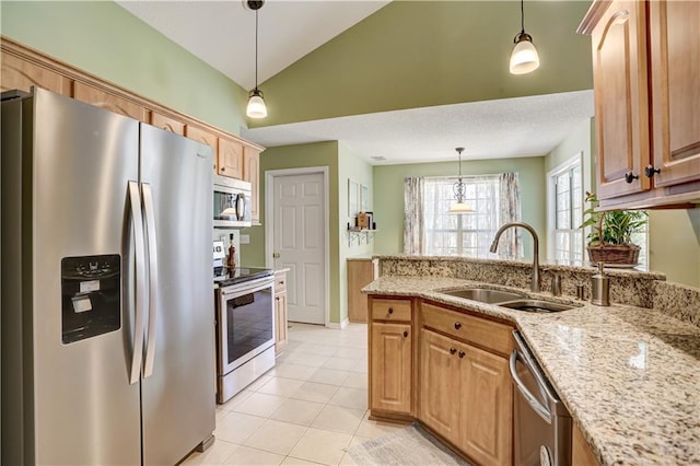 kitchen with light tile patterned floors, lofted ceiling, decorative light fixtures, stainless steel appliances, and a sink