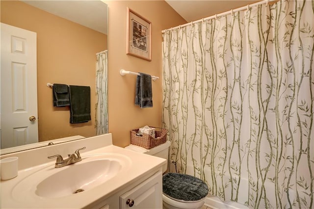 bathroom featuring shower / bath combination with curtain, vanity, and toilet