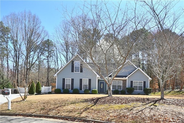 traditional-style home featuring fence