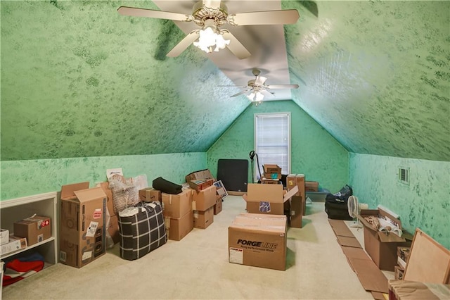 interior space featuring lofted ceiling, a textured ceiling, carpet flooring, and wallpapered walls