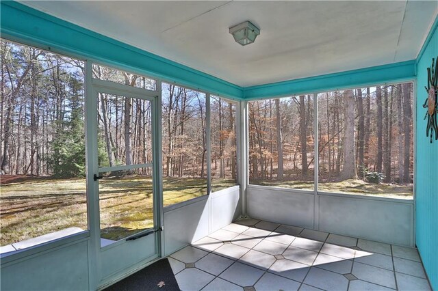 unfurnished sunroom with plenty of natural light