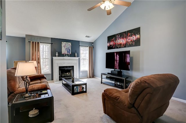 carpeted living room with high vaulted ceiling, a premium fireplace, a ceiling fan, visible vents, and baseboards